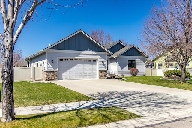 view of front of property featuring board and batten siding, an attached garage, driveway, and stone siding