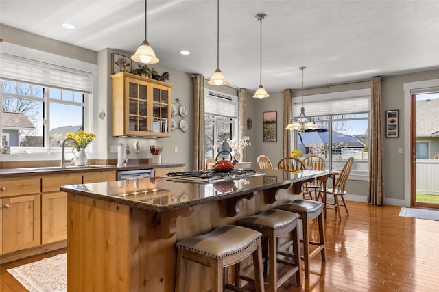 kitchen with a healthy amount of sunlight, stainless steel gas cooktop, and wood-type flooring