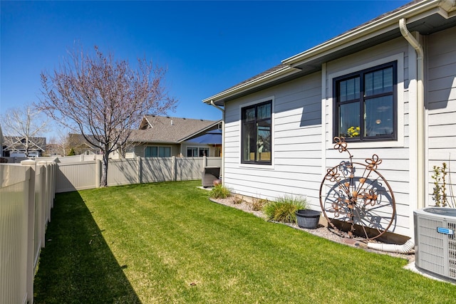 view of yard featuring central air condition unit and a fenced backyard