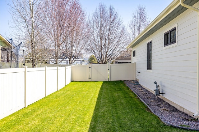 view of yard with a gate and a fenced backyard