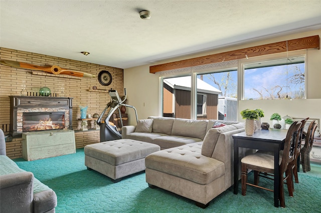carpeted living room featuring a textured ceiling, a brick fireplace, and brick wall