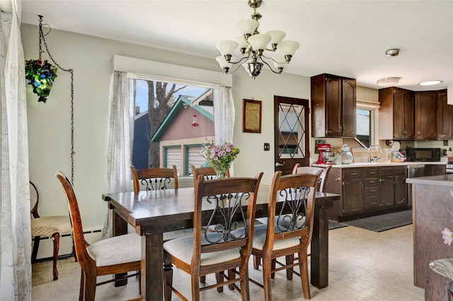 dining space featuring a chandelier and a baseboard heating unit