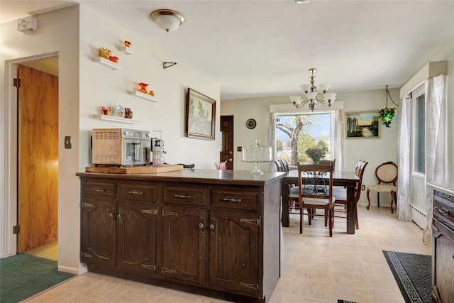 1317 River Rd, Missoula, MT 59801 - kitchen with dark brown cabinets and a chandelier