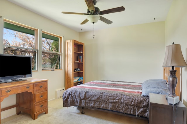 bedroom featuring ceiling fan, baseboard heating, and light colored carpet