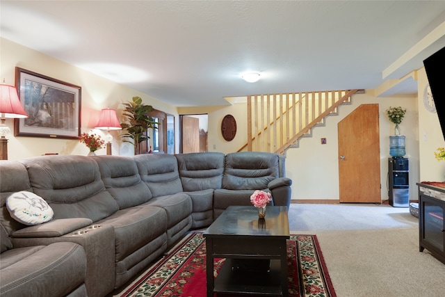 living room featuring carpet floors and stairway