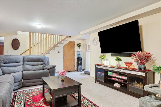 living area with carpet flooring and stairs