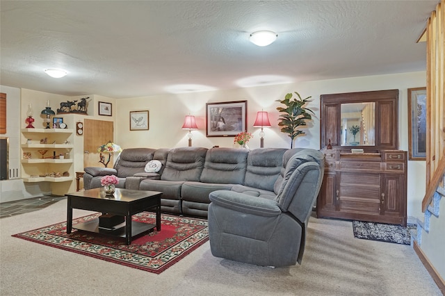 living area featuring a textured ceiling and light colored carpet