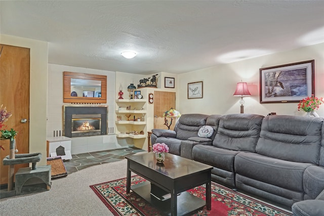 carpeted living room with a fireplace and a textured ceiling