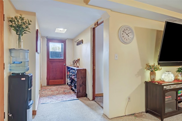 hall with light colored carpet