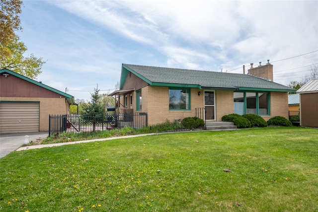 single story home with fence, aphalt driveway, a garage, brick siding, and a front yard