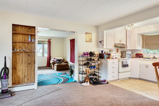 1317 River Rd, Missoula, MT 59801 - kitchen featuring white electric range oven, under cabinet range hood, white cabinetry, and healthy amount of natural light
