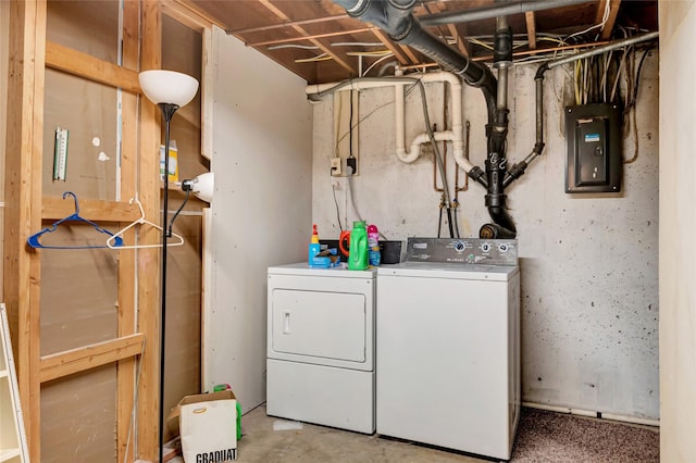 washroom with laundry area, washer and clothes dryer, and electric panel