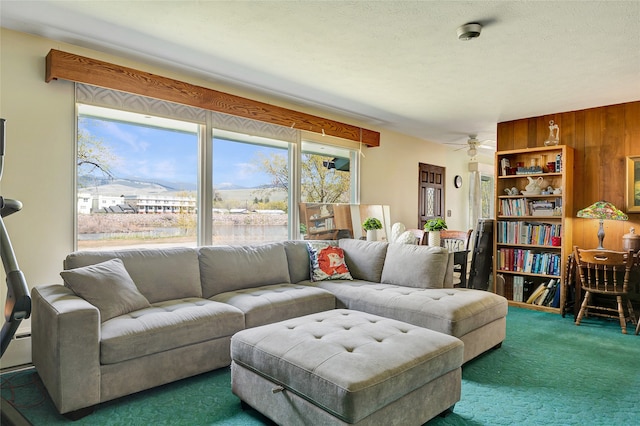 carpeted living area featuring a ceiling fan and a wealth of natural light