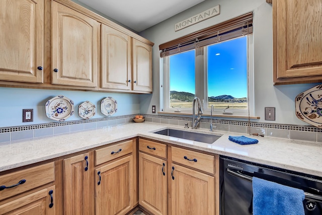kitchen with light brown cabinetry, light stone countertops, a sink, and dishwasher