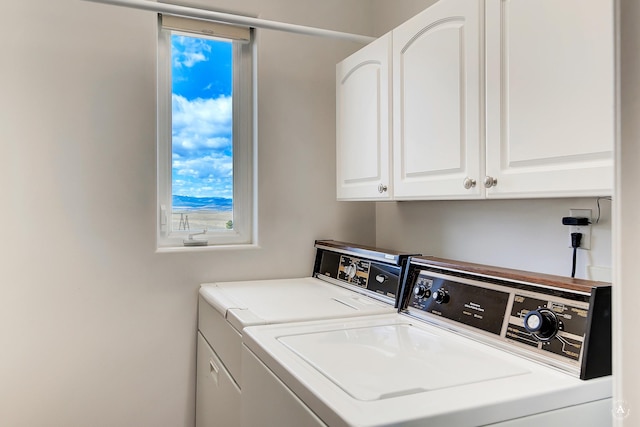 laundry area featuring cabinet space and washing machine and clothes dryer