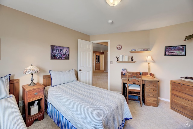 bedroom with baseboards and light carpet