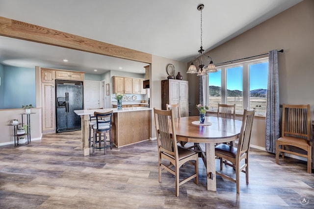 dining area with baseboards, recessed lighting, lofted ceiling, and a notable chandelier