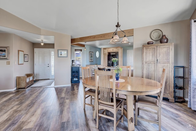 dining room featuring baseboards and wood finished floors