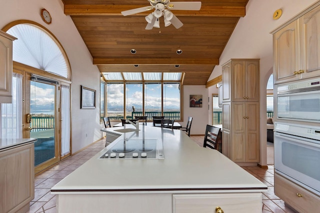 kitchen featuring black electric cooktop, ceiling fan, light tile patterned flooring, and wooden ceiling