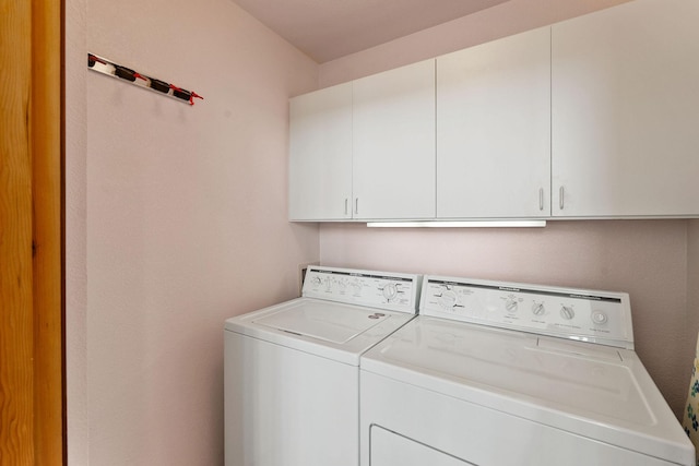 washroom featuring cabinet space and washer and dryer