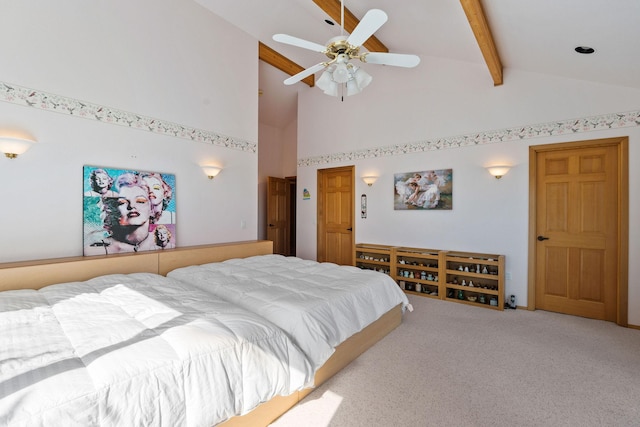bedroom with carpet, ceiling fan, beam ceiling, and high vaulted ceiling