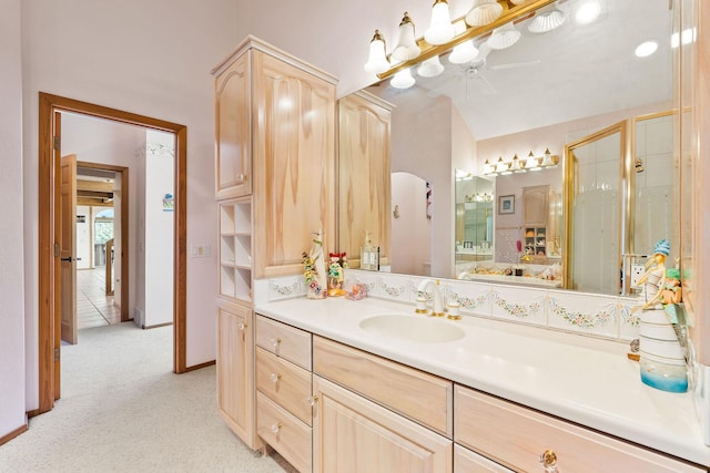 full bath with vanity, baseboards, and a stall shower