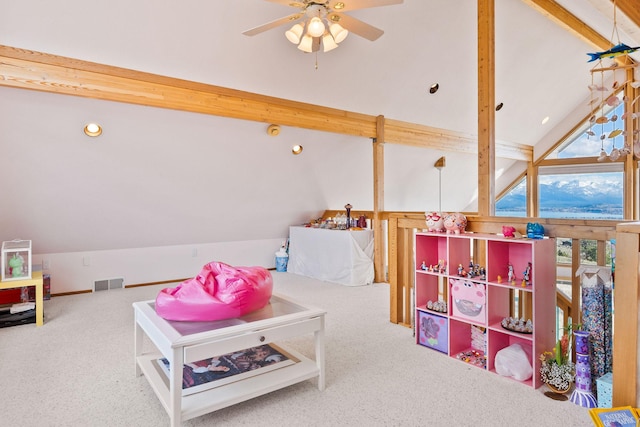 playroom featuring vaulted ceiling with beams, carpet flooring, a ceiling fan, and visible vents