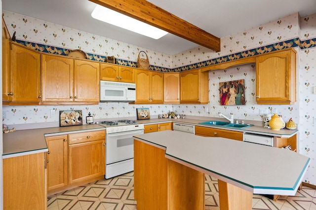 kitchen featuring a kitchen island, beam ceiling, a sink, wallpapered walls, and white appliances