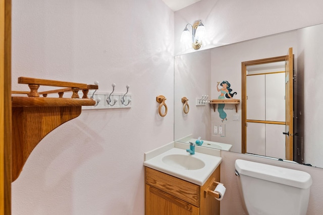 half bathroom with toilet and vanity