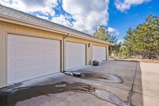 garage featuring concrete driveway