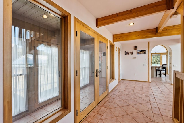 interior space featuring beamed ceiling, recessed lighting, french doors, arched walkways, and light tile patterned floors