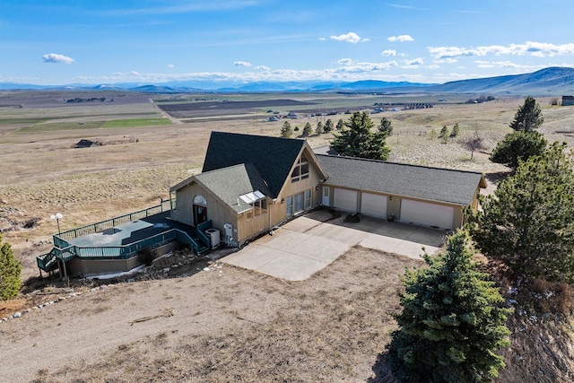 birds eye view of property featuring a mountain view and a rural view