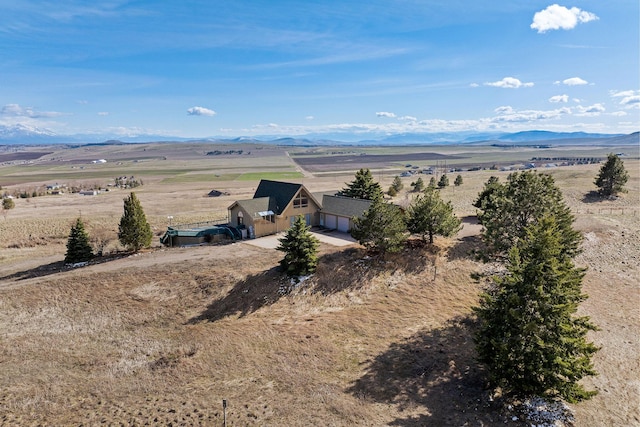 drone / aerial view featuring a mountain view and a rural view