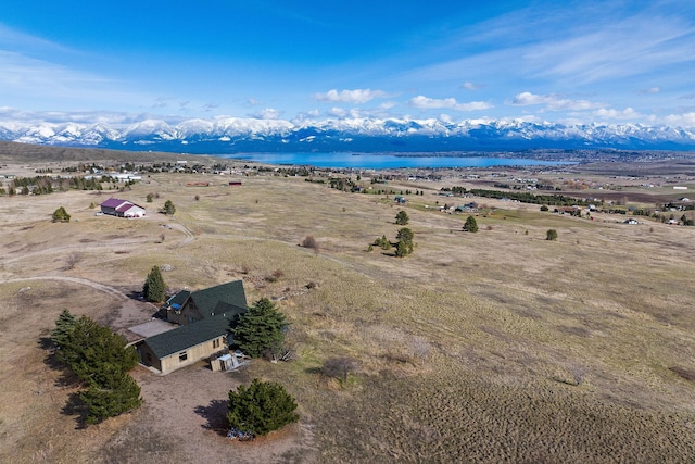 drone / aerial view with a water and mountain view and a rural view