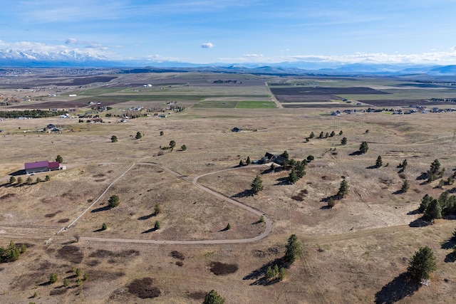 drone / aerial view featuring a mountain view and a rural view
