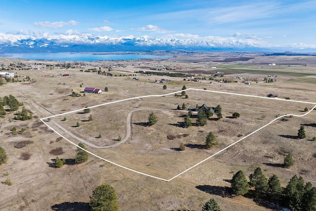 birds eye view of property featuring a water view and a rural view