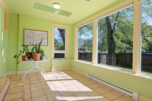 unfurnished sunroom featuring tile patterned flooring, baseboards, and baseboard heating