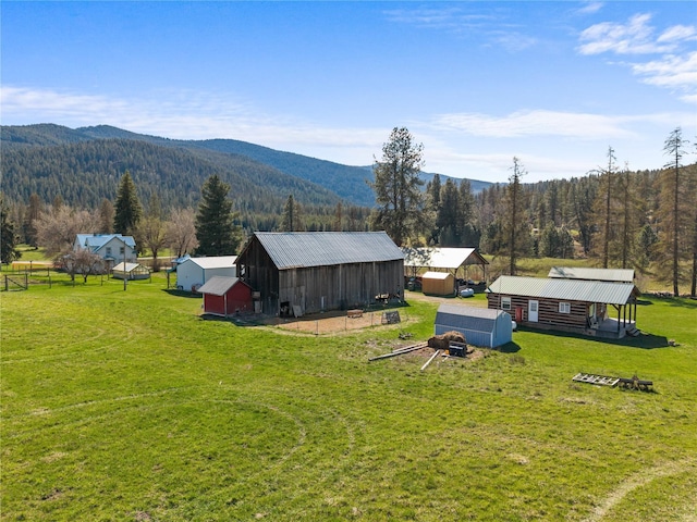 exterior space featuring a mountain view and a wooded view