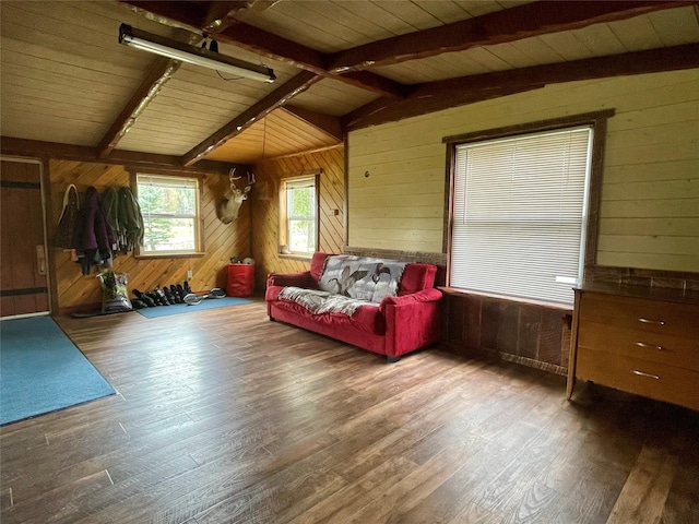 living room featuring vaulted ceiling with beams, wood walls, wood finished floors, and wooden ceiling