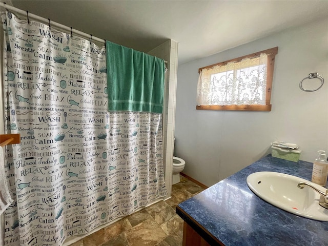 bathroom with vanity, toilet, and a shower with curtain