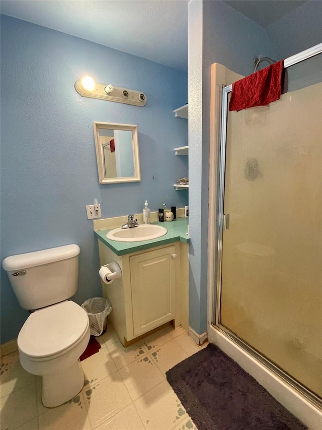 full bathroom with vanity, toilet, tile patterned floors, and a stall shower
