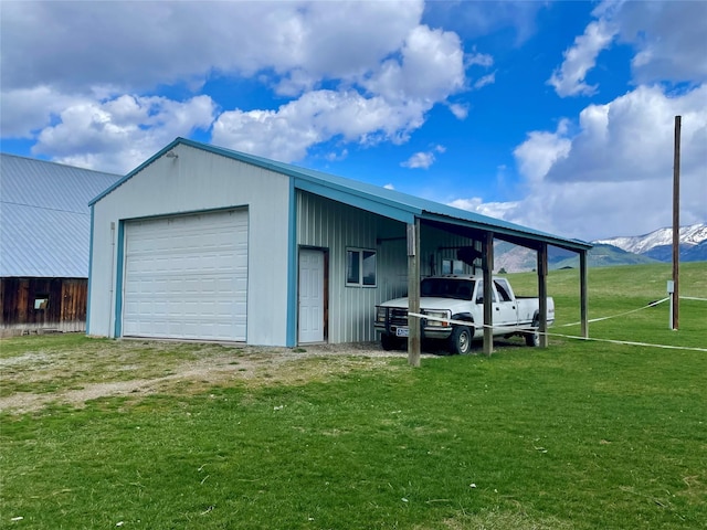 garage featuring a detached garage and a mountain view