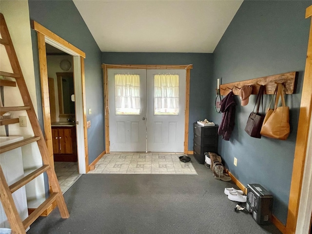 interior space featuring carpet flooring, baseboards, french doors, and lofted ceiling