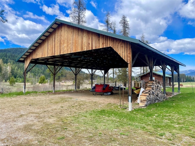 view of car parking with a mountain view and a carport