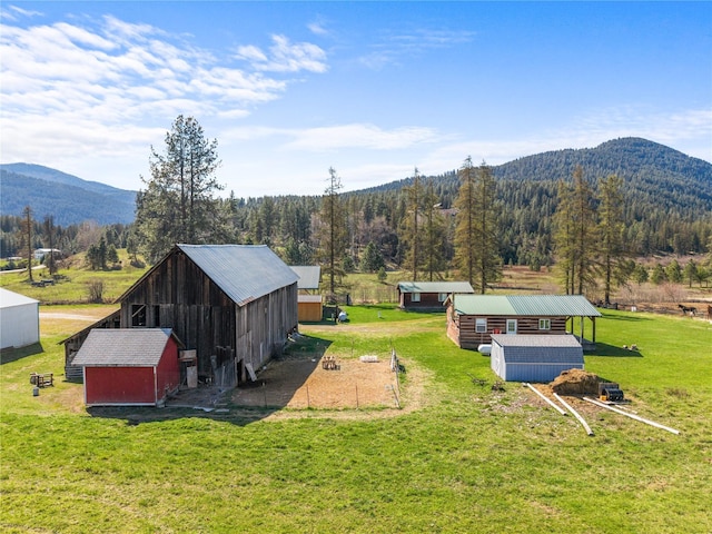 exterior space featuring a forest view and a mountain view
