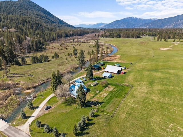 aerial view with a water and mountain view and a rural view