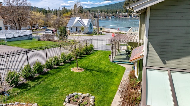 view of yard featuring a mountain view and fence private yard