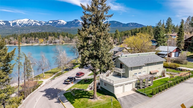bird's eye view with a view of trees and a water and mountain view