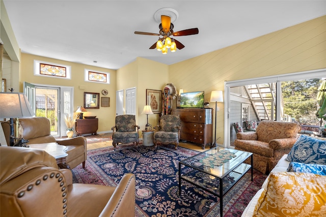living area featuring plenty of natural light, baseboards, ceiling fan, and wood finished floors
