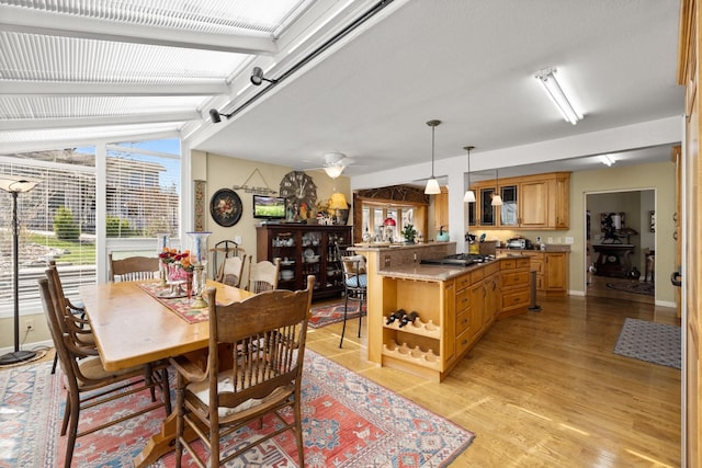 dining space featuring baseboards and light wood-style flooring